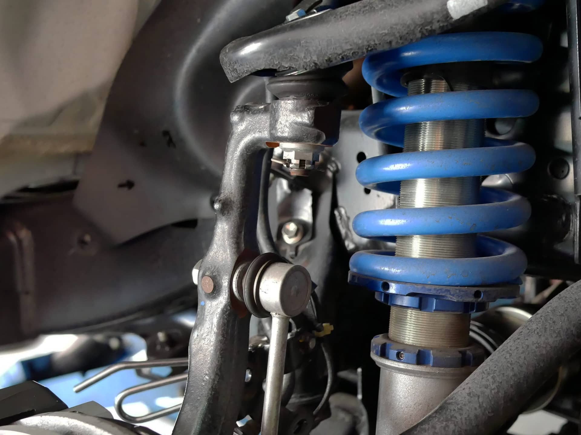 Mechanic Maintaining Car Shock Absorber